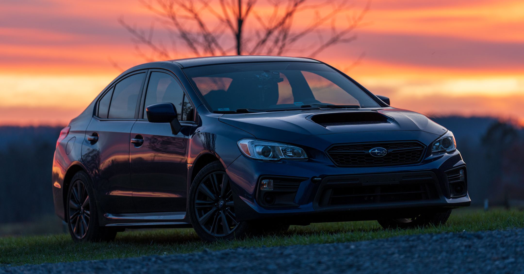 Subaru WRX parked on a Tennessee road at sunset