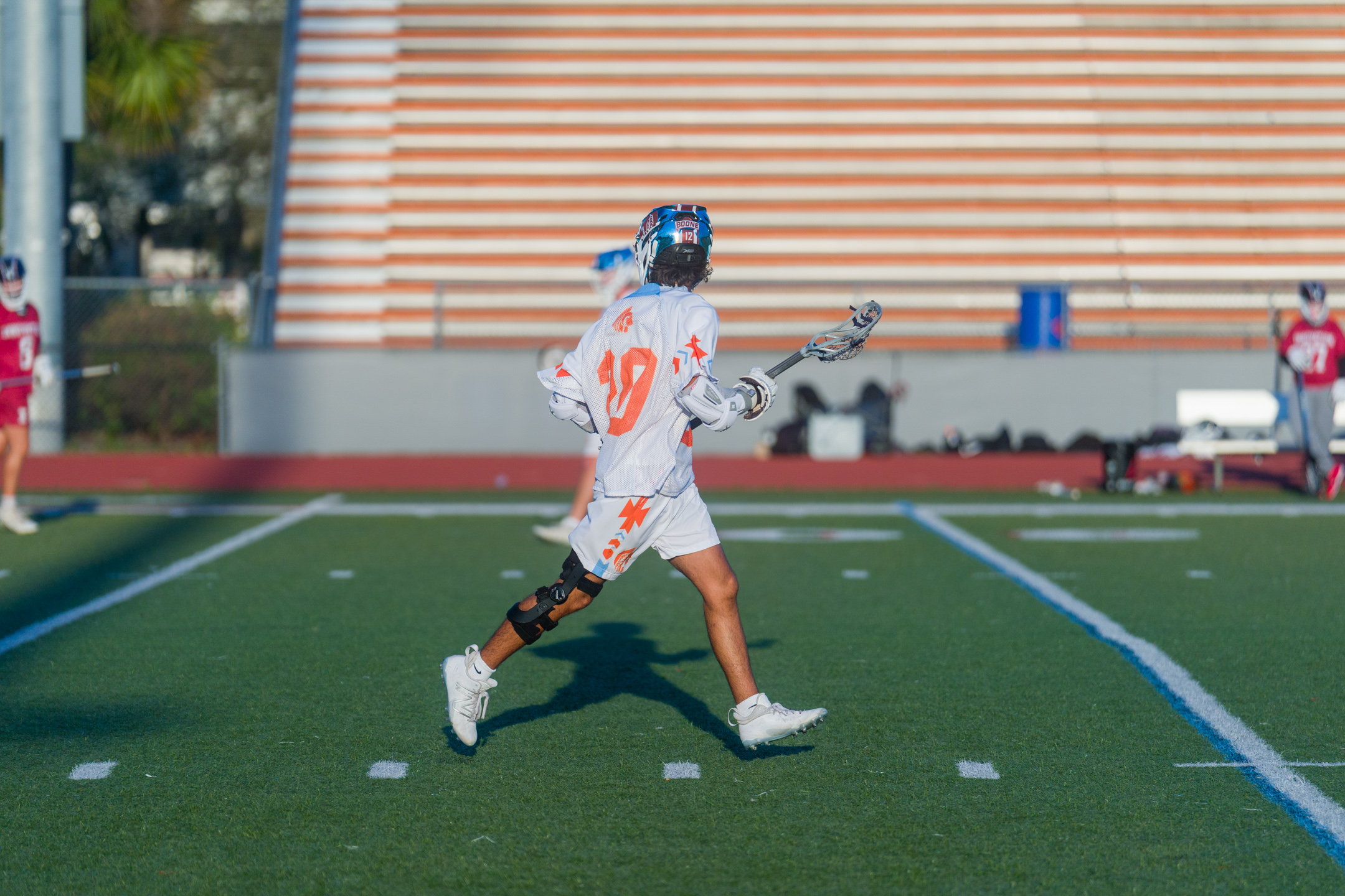 Lacrosse player running with the ball