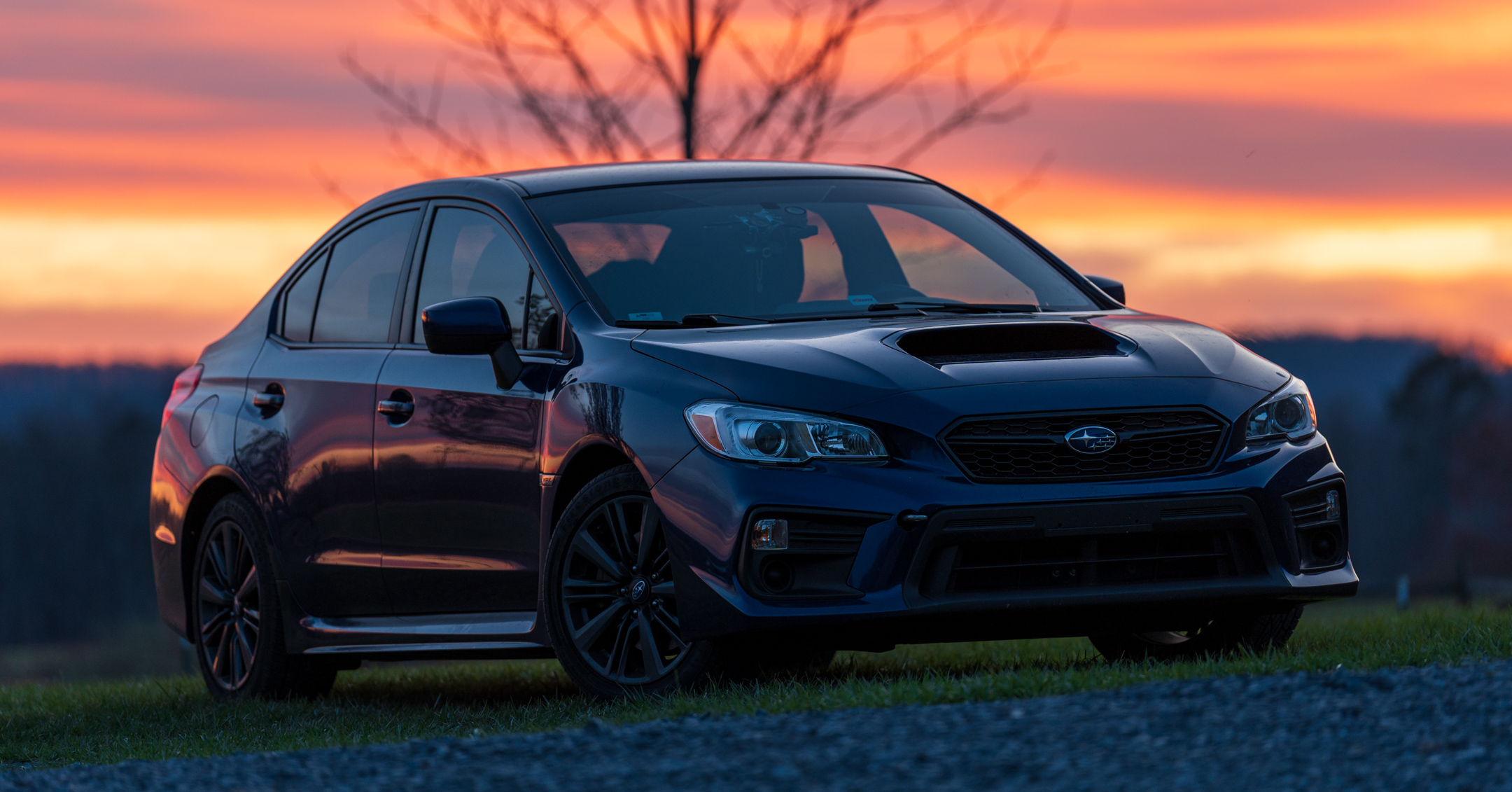 Subaru WRX parked on a Tennessee road at sunset